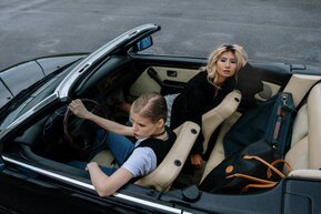 Couple in a Mercedes SLK on a scenic Swiss alpine road
